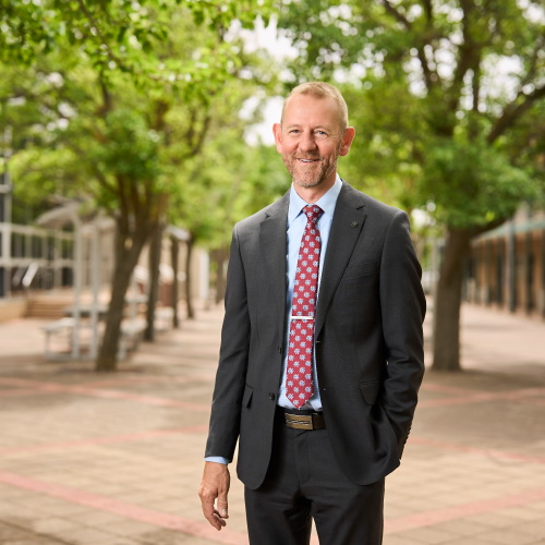 The Principal of Faith Lutheran College smiles for the camera