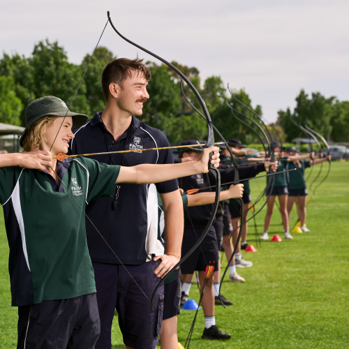 Multiple Faith Lutheran College Students being taught archery